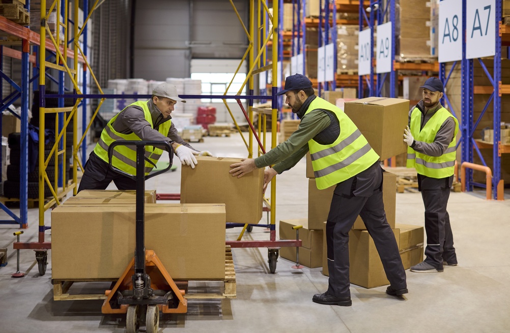 Workers,In,Warehouse,Loading,Boxes,On,Pallet.,Loaders,Prepare,Shipment